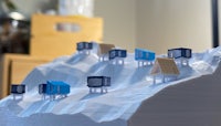 3d printed huts on top of a mountain