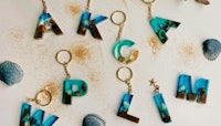a group of sea shells and letters on a beach